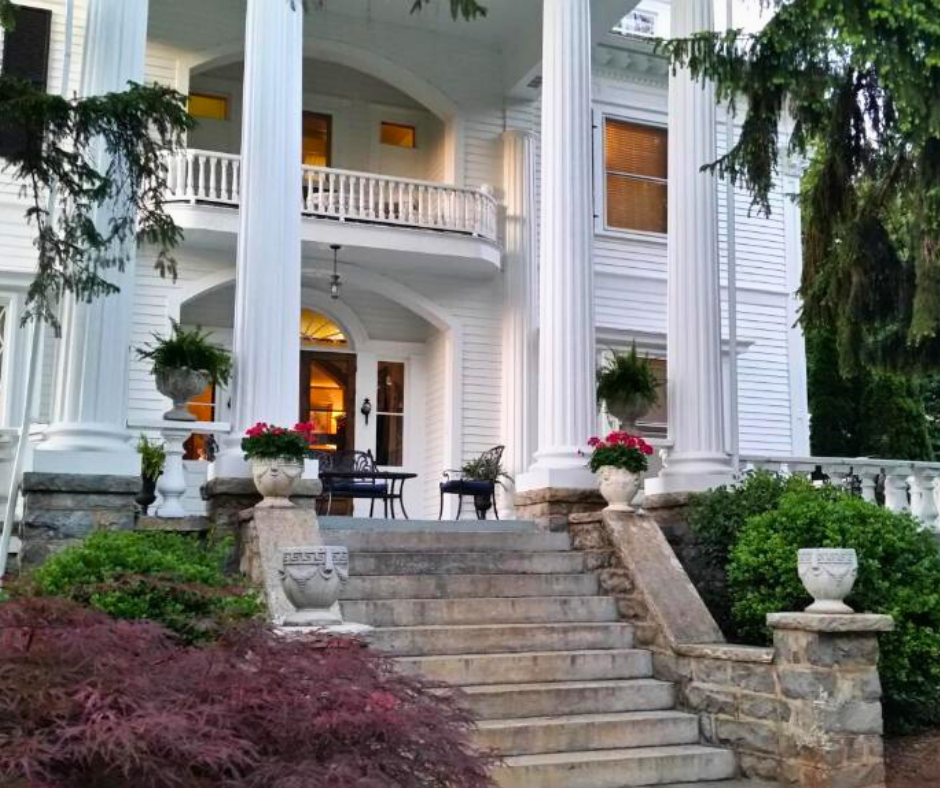 historic white manor surrounded by s summer sunset and lush green trees