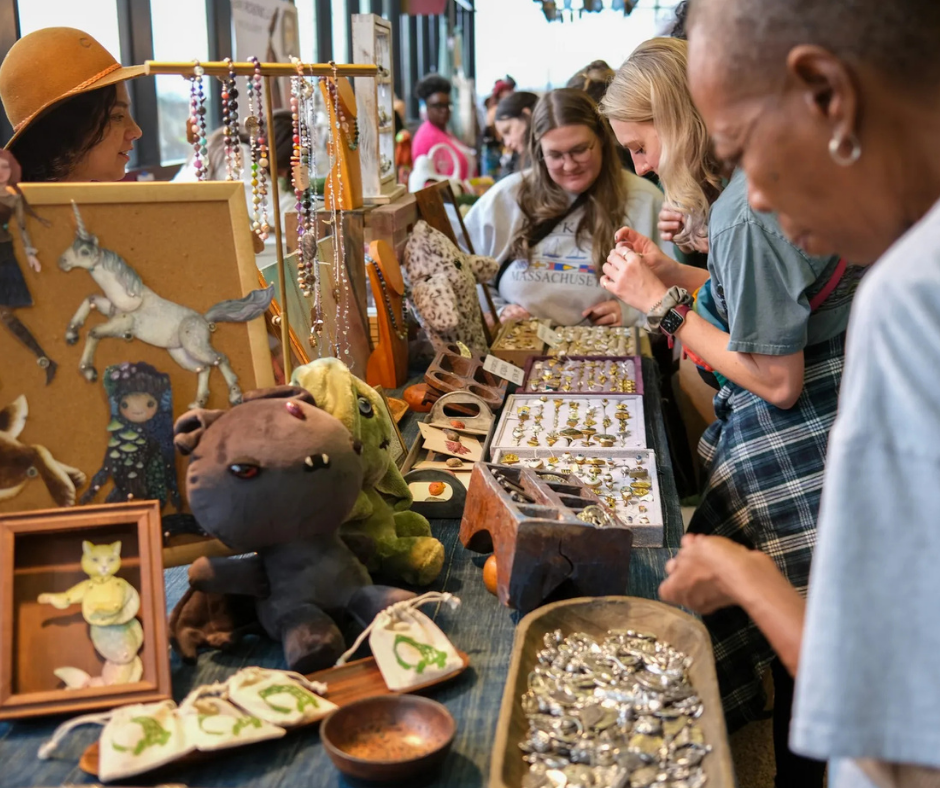 An image of antique show goers looking around a booth at the show